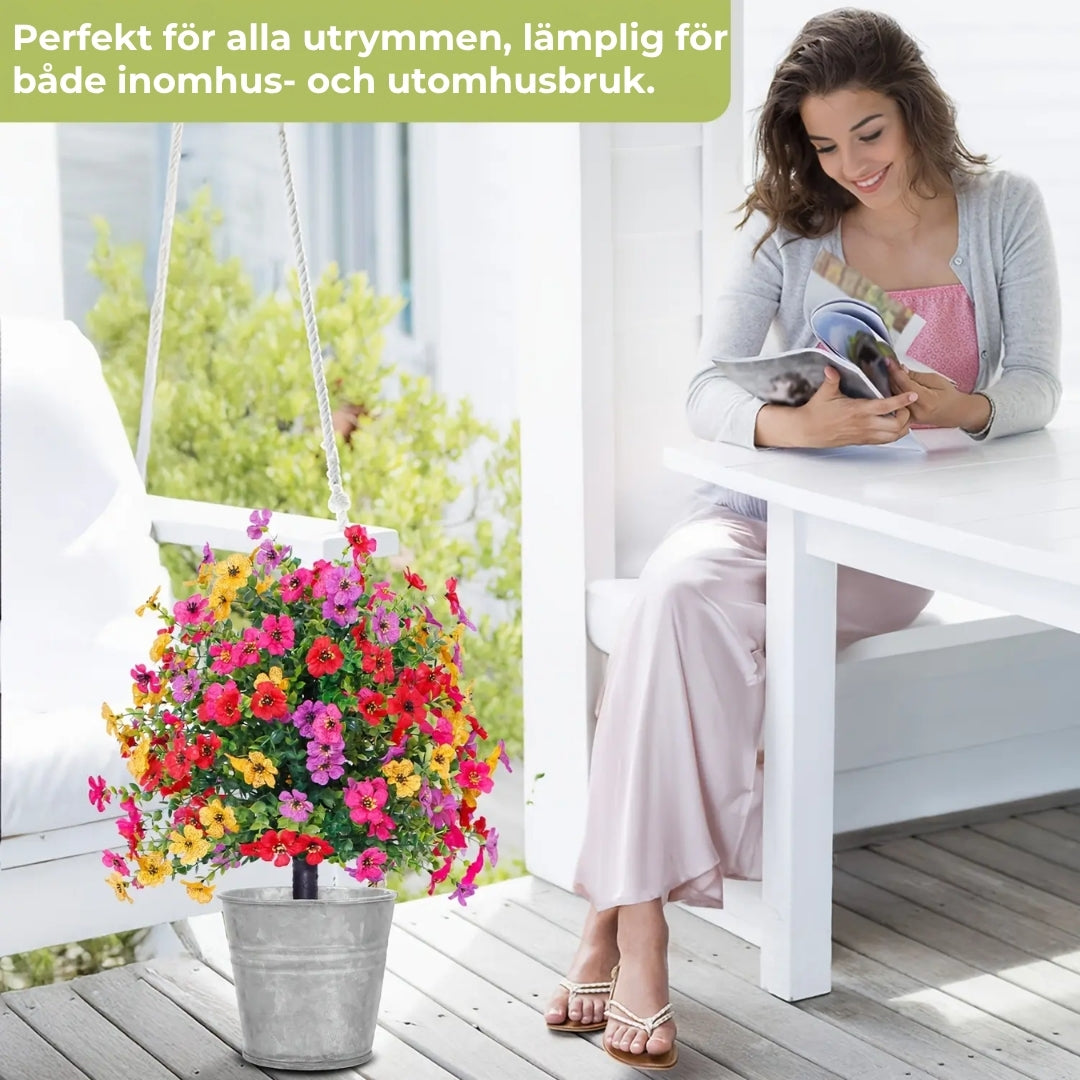 Blomsterarrangemang med konstgjord eukalyptus och violer